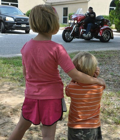 child holding ears loud motorcycle cropped
